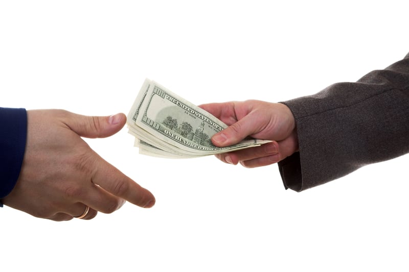 hands passing money to represent small business money collections