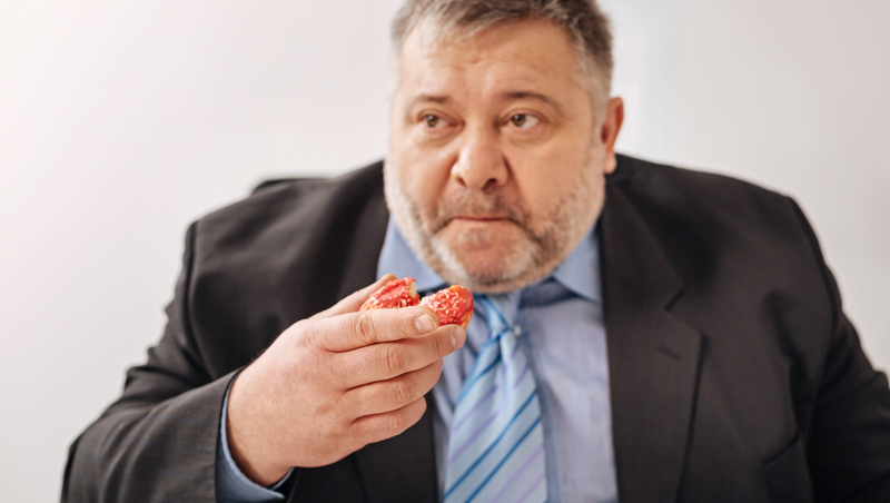 stressed office worker eating donut Viacheslav Iacobchuk Dreamstime.com. For Quit Bad Habits to Reduce Stress