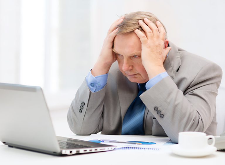Stressed businessman at laptop