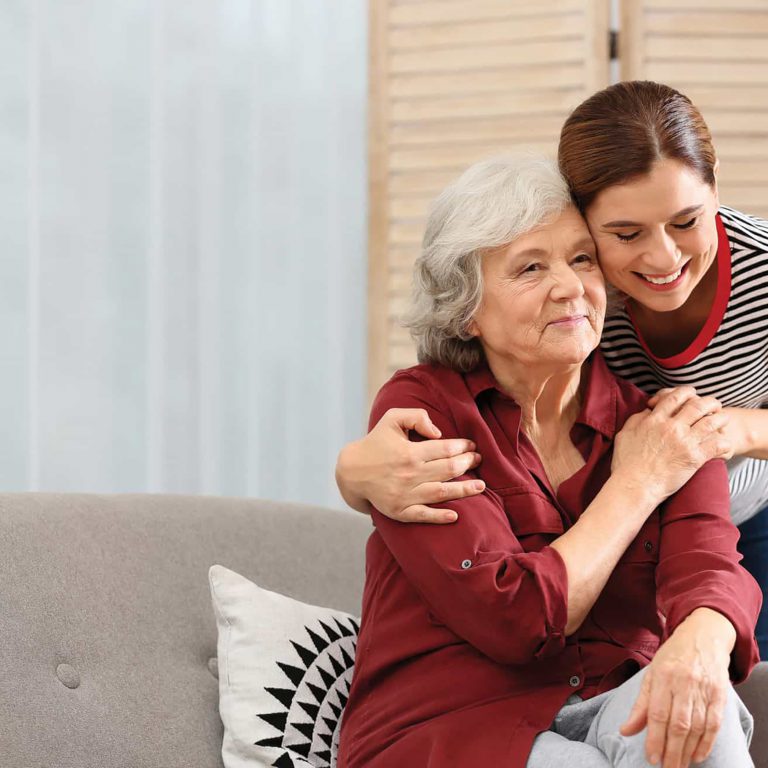 Senior woman with adult daughter embracing